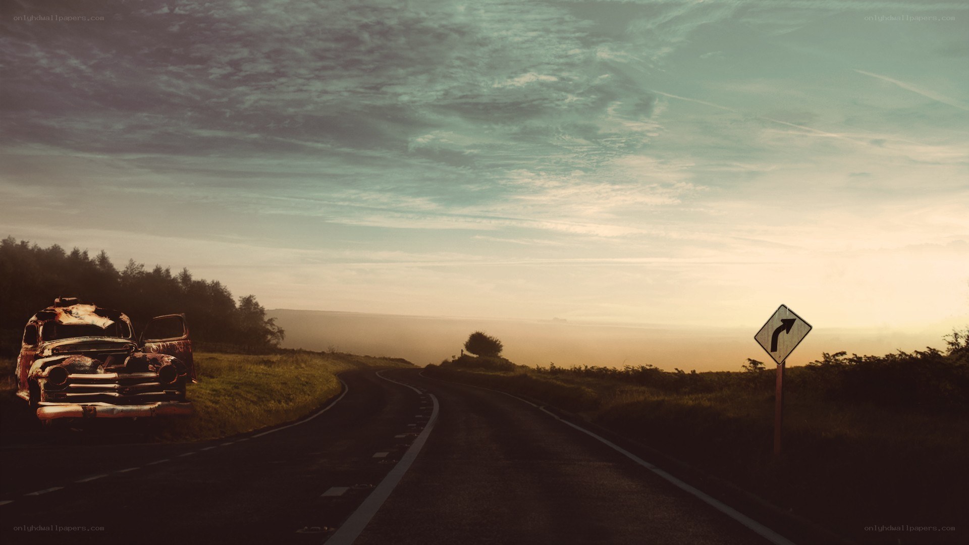 Abandoned car on a winding road