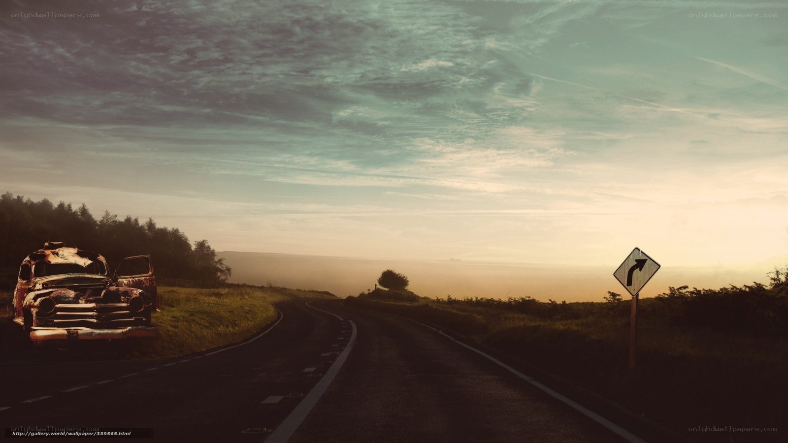Abandoned car on a winding road