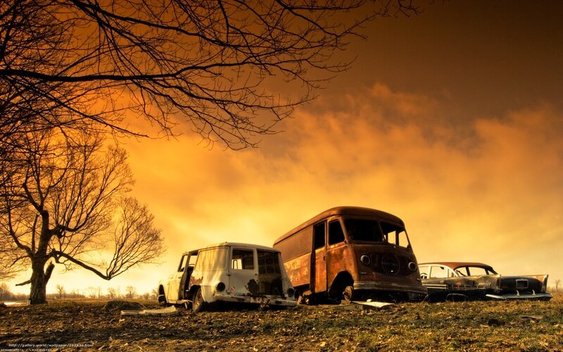 abandoned cars at sunset