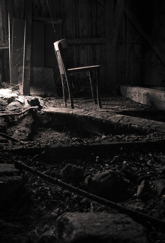 abandoned chair in dark room