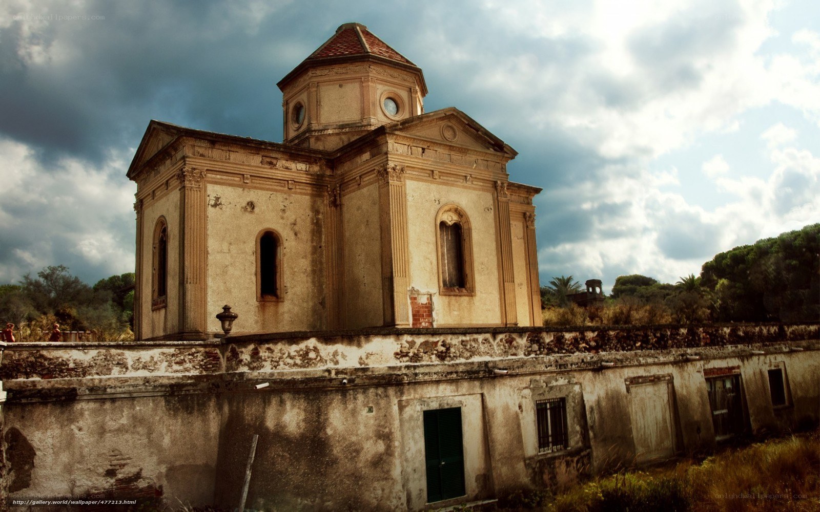 Abandoned chapel under cloudy sky