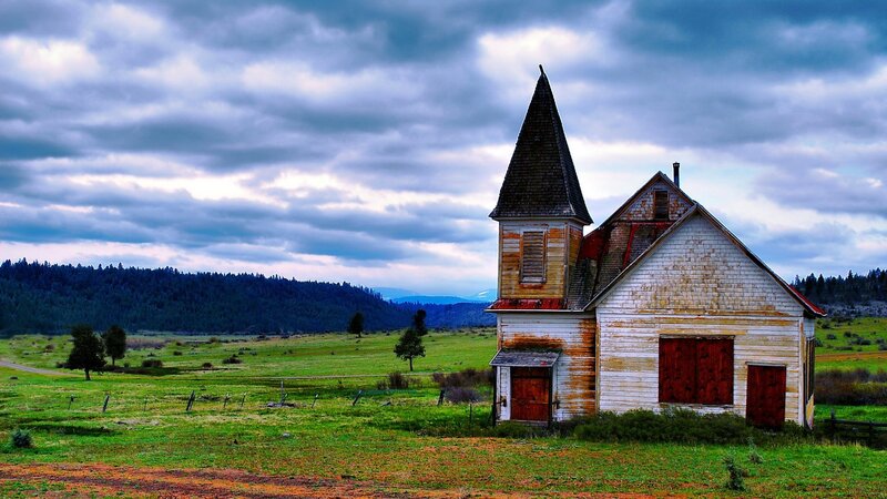 Abandoned church in a green field