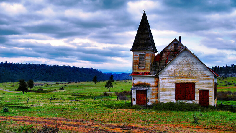 Abandoned church in a green field