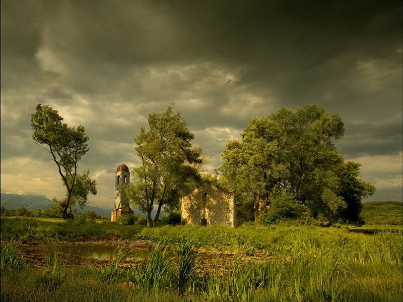 Abandoned church in a green field