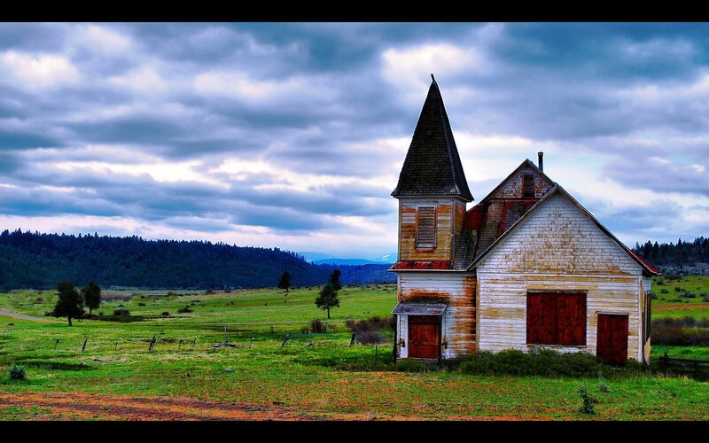 Abandoned church in a green field