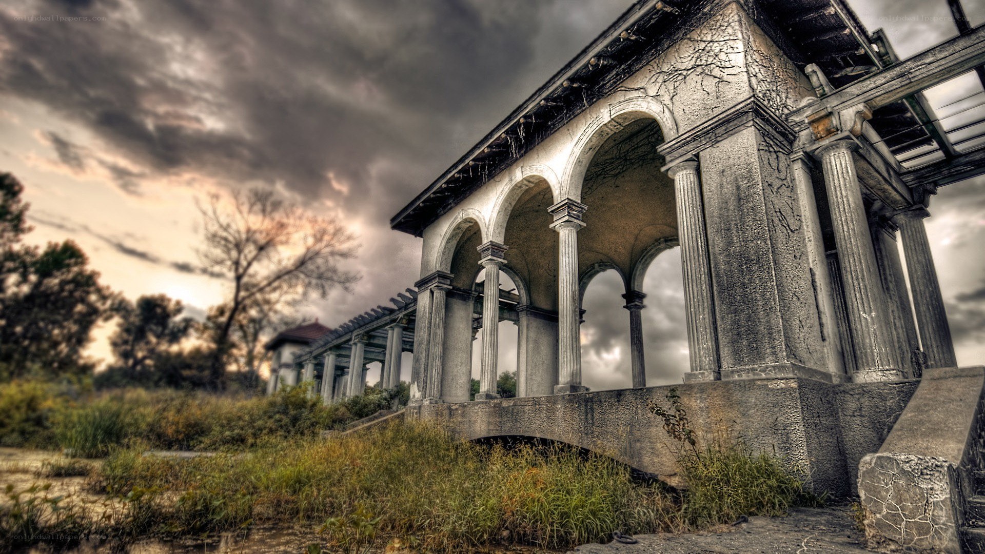abandoned colonnade under stormy sky