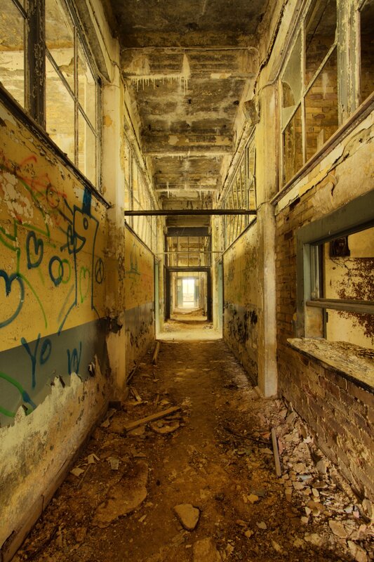 abandoned corridor with graffiti