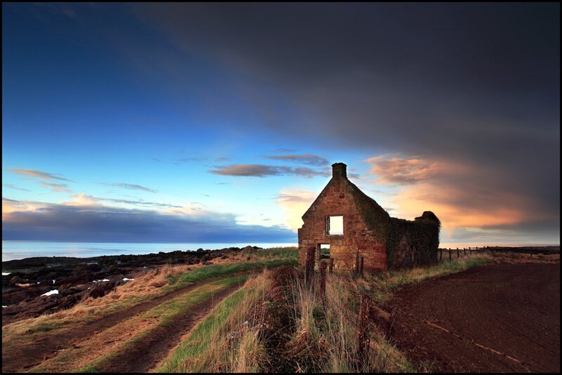 Abandoned cottage at sunset
