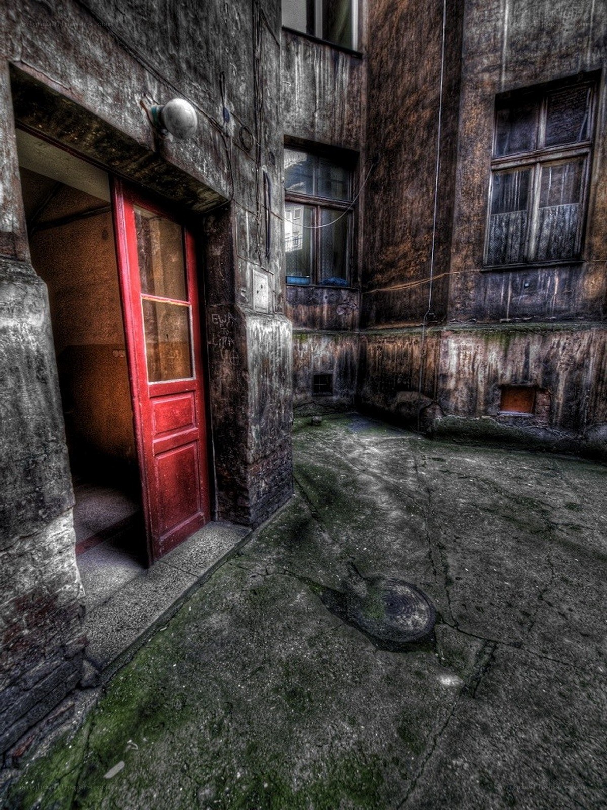 abandoned courtyard with red door