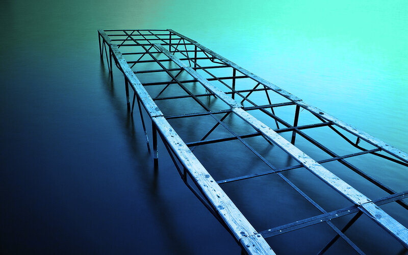 Abandoned dock on calm water