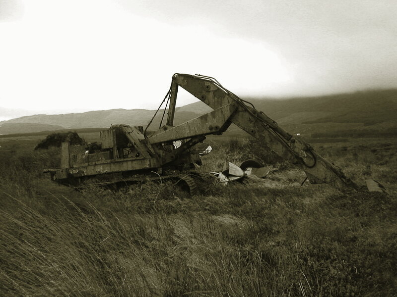 Abandoned excavator in field