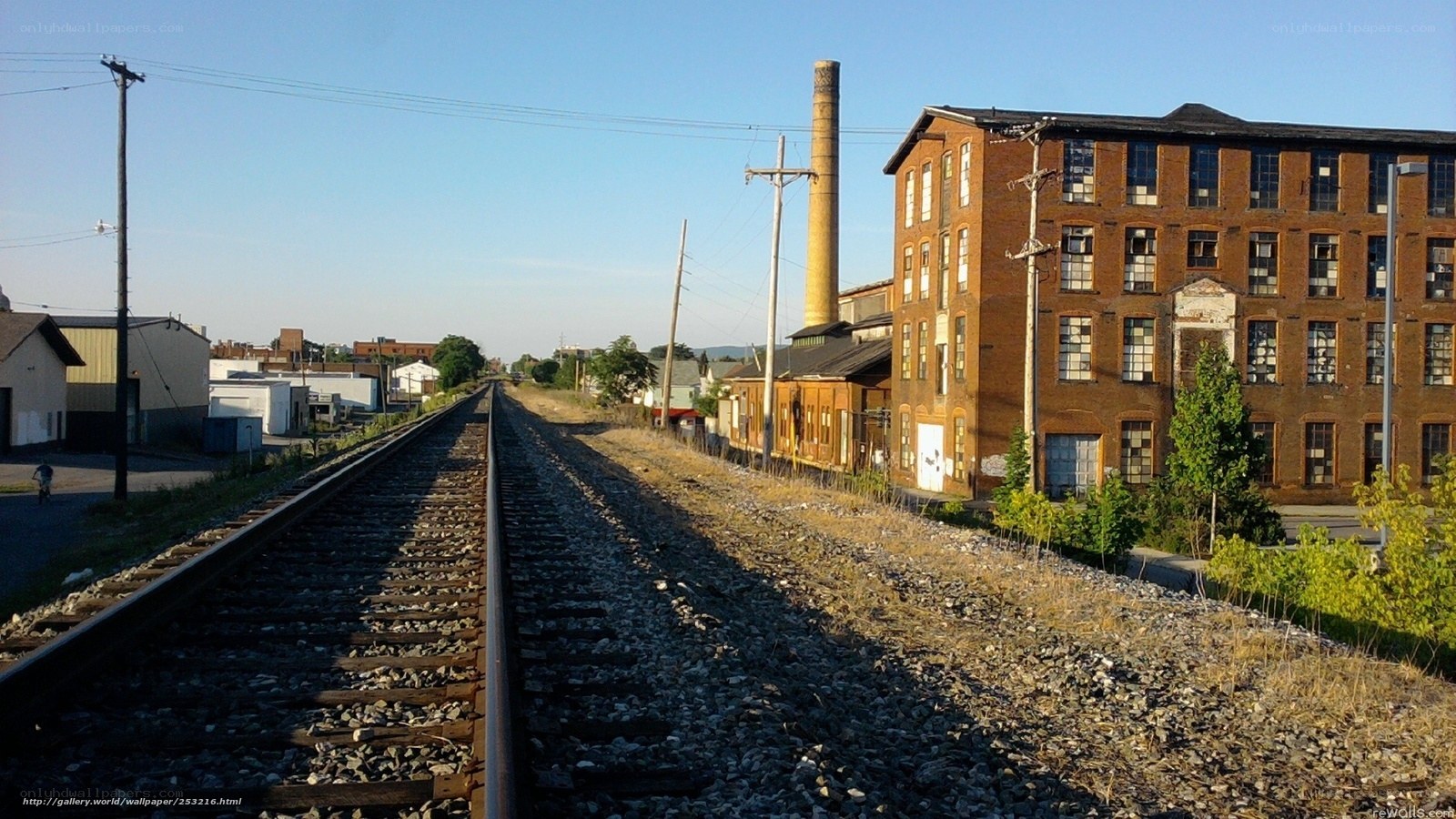 Abandoned factory by train tracks