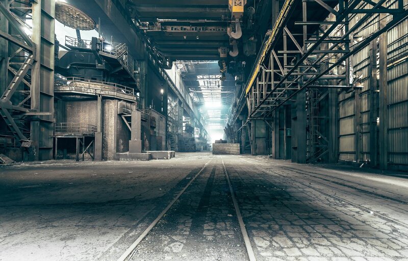 Abandoned Factory Interior — Gray, Desolate, Photograph, Rail Tracks