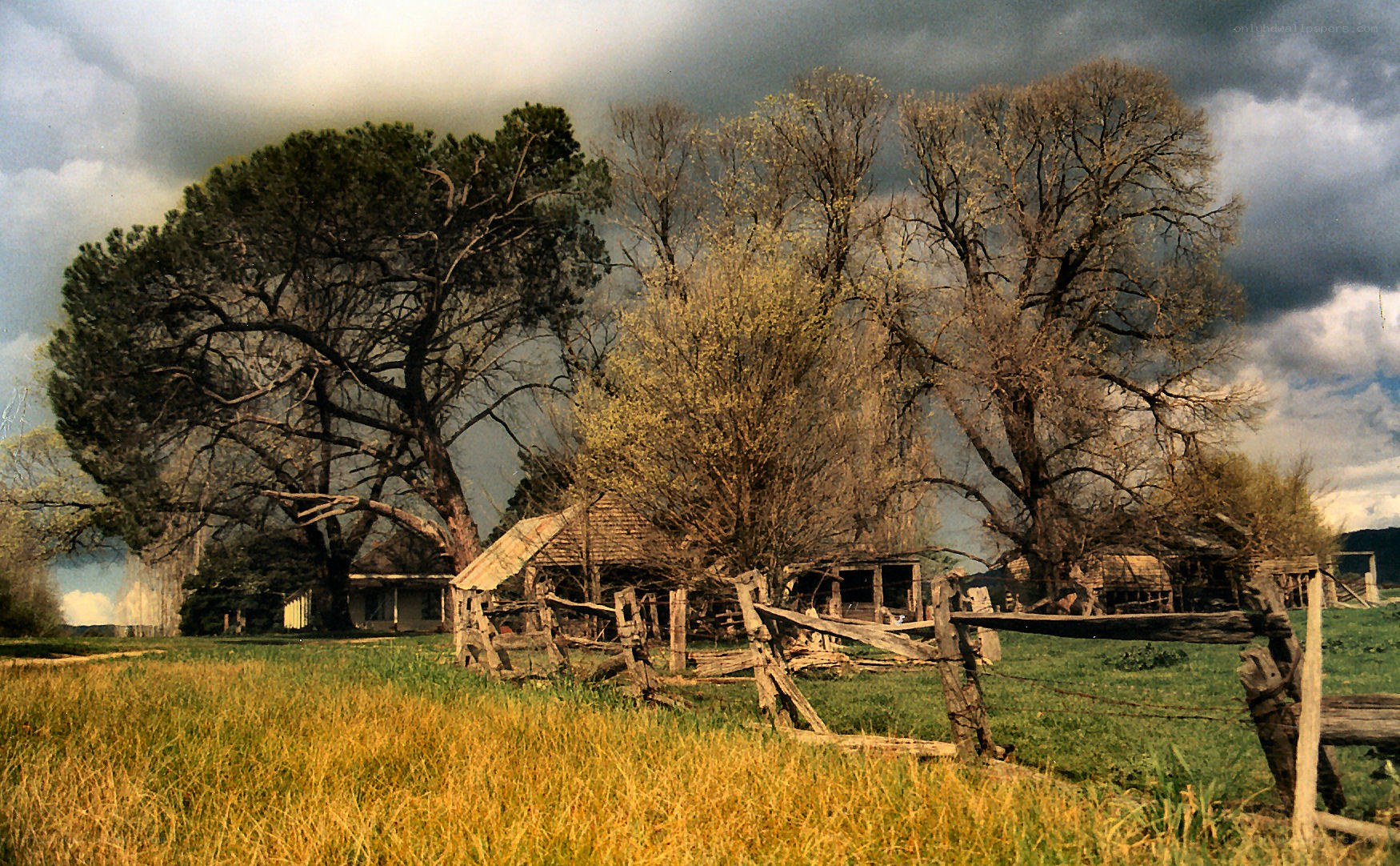 Abandoned farm under stormy sky
