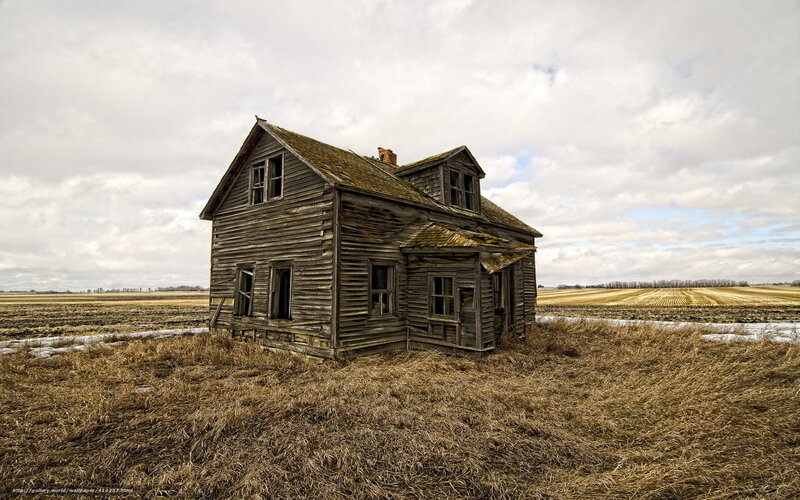 Abandoned farmhouse in field