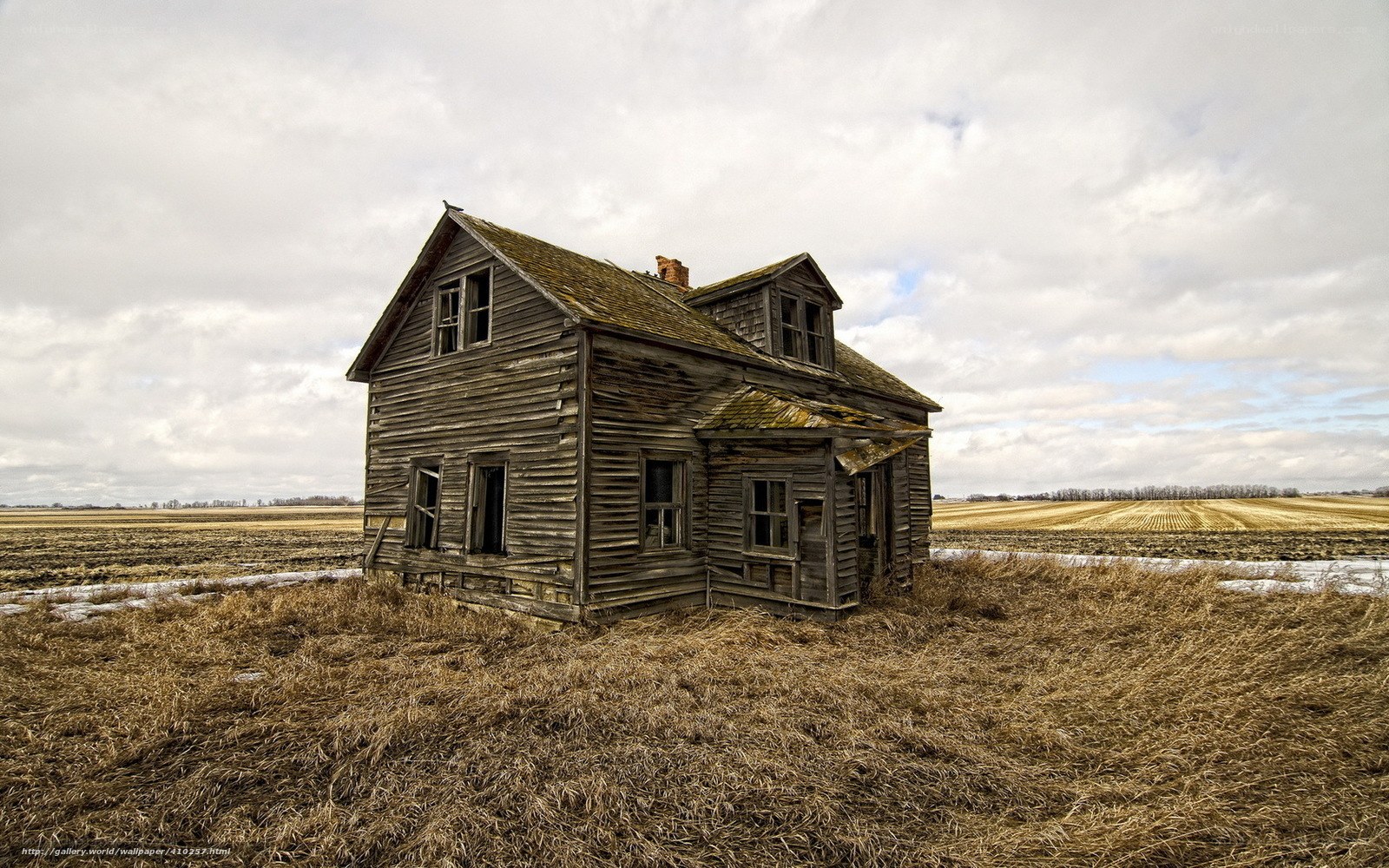 Abandoned farmhouse in field
