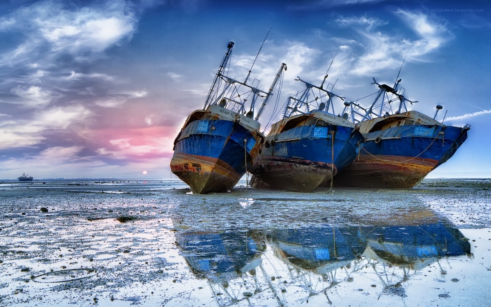Abandoned fishing boats at sunset