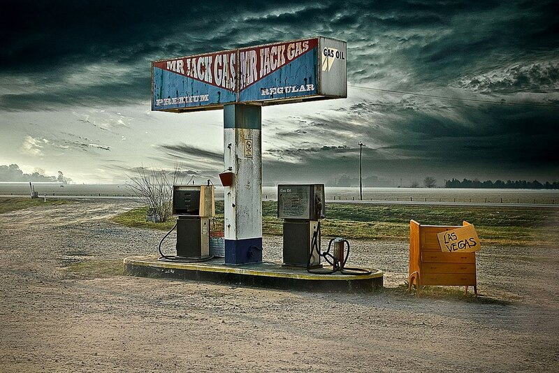 abandoned gas station under stormy sky