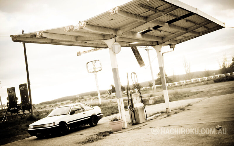 Abandoned gas station with white car