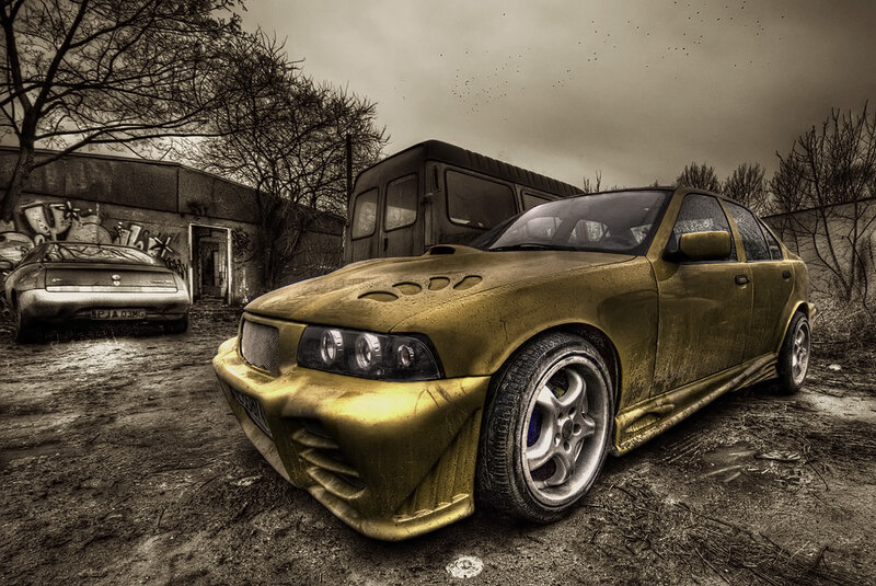 abandoned gold car in junkyard