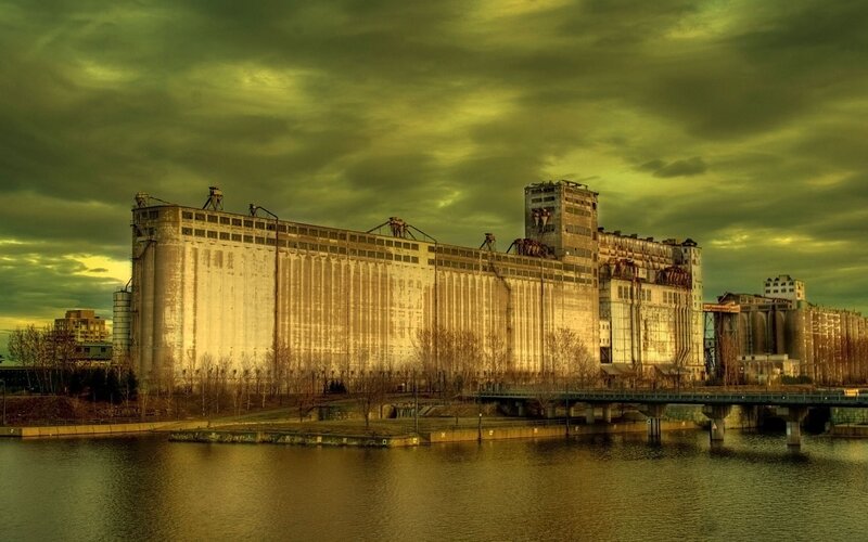 Abandoned grain silos by river