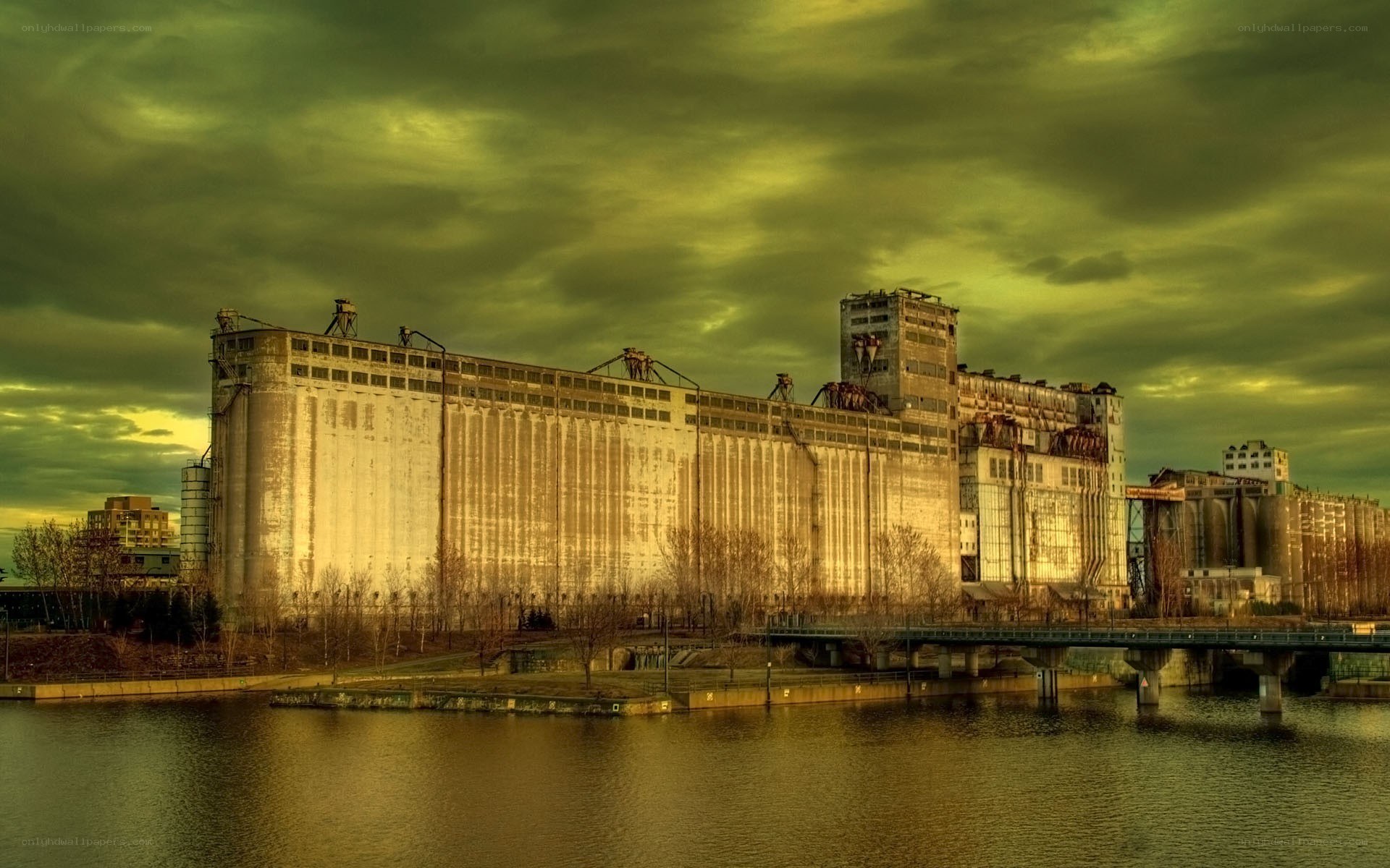 Abandoned grain silos by river