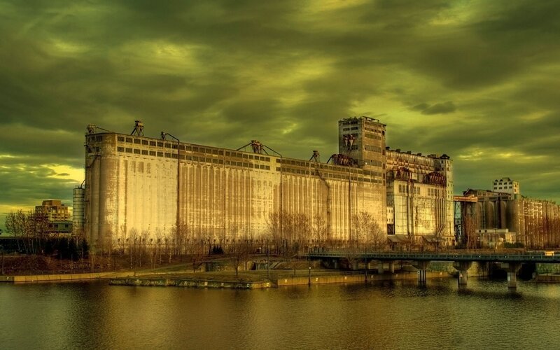 Abandoned grain silos by river