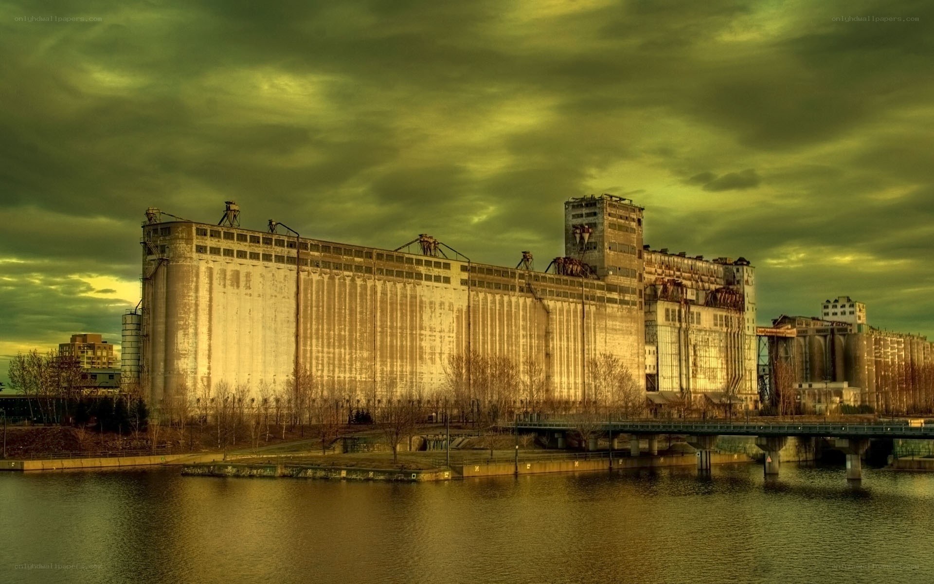 Abandoned grain silos by river
