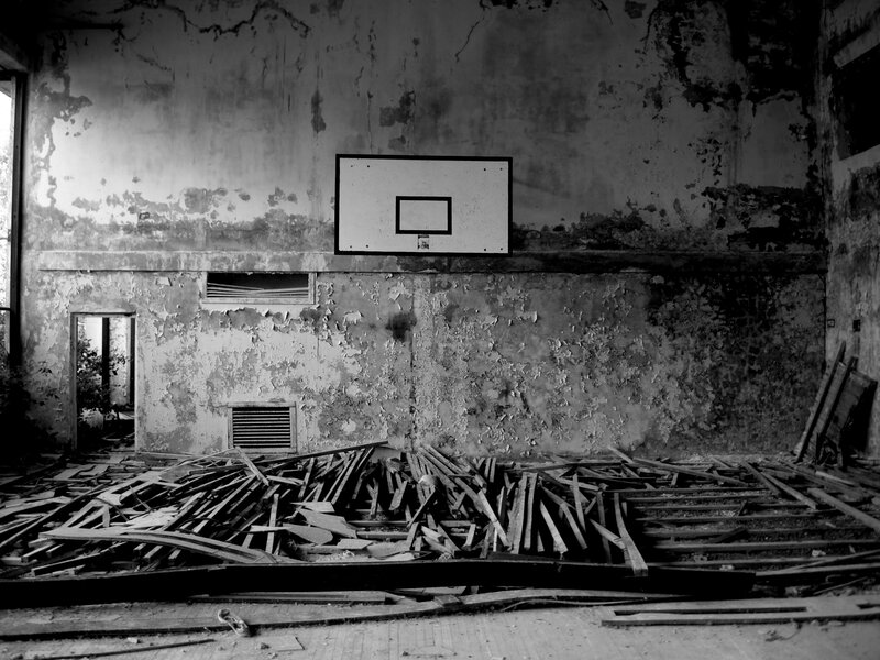 Abandoned gym with basketball hoop