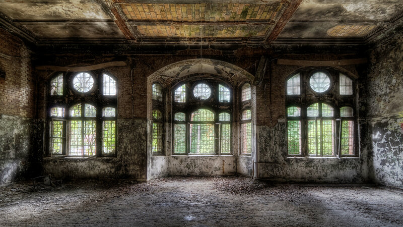 Abandoned hall with arched windows