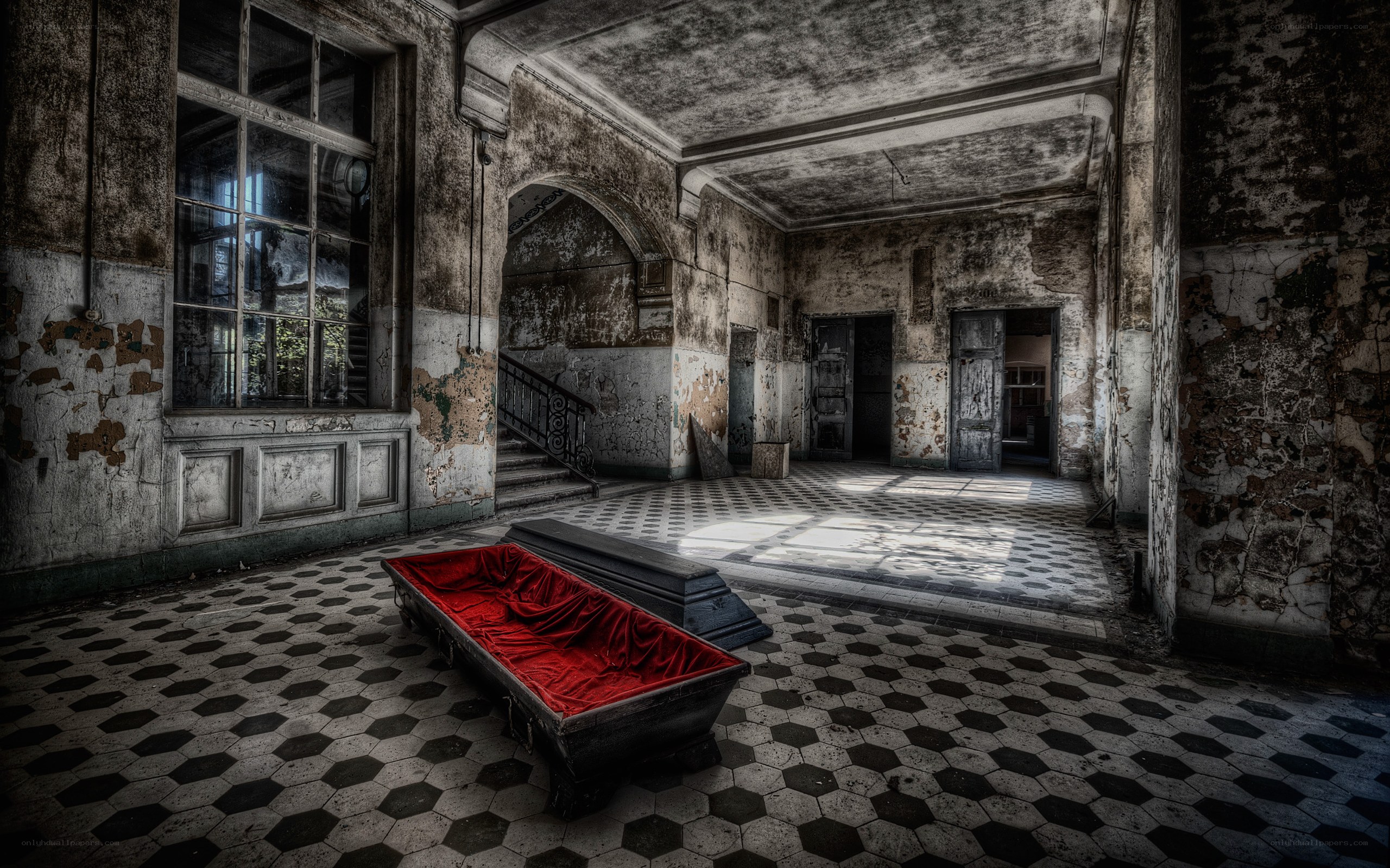 Abandoned hall with red coffin