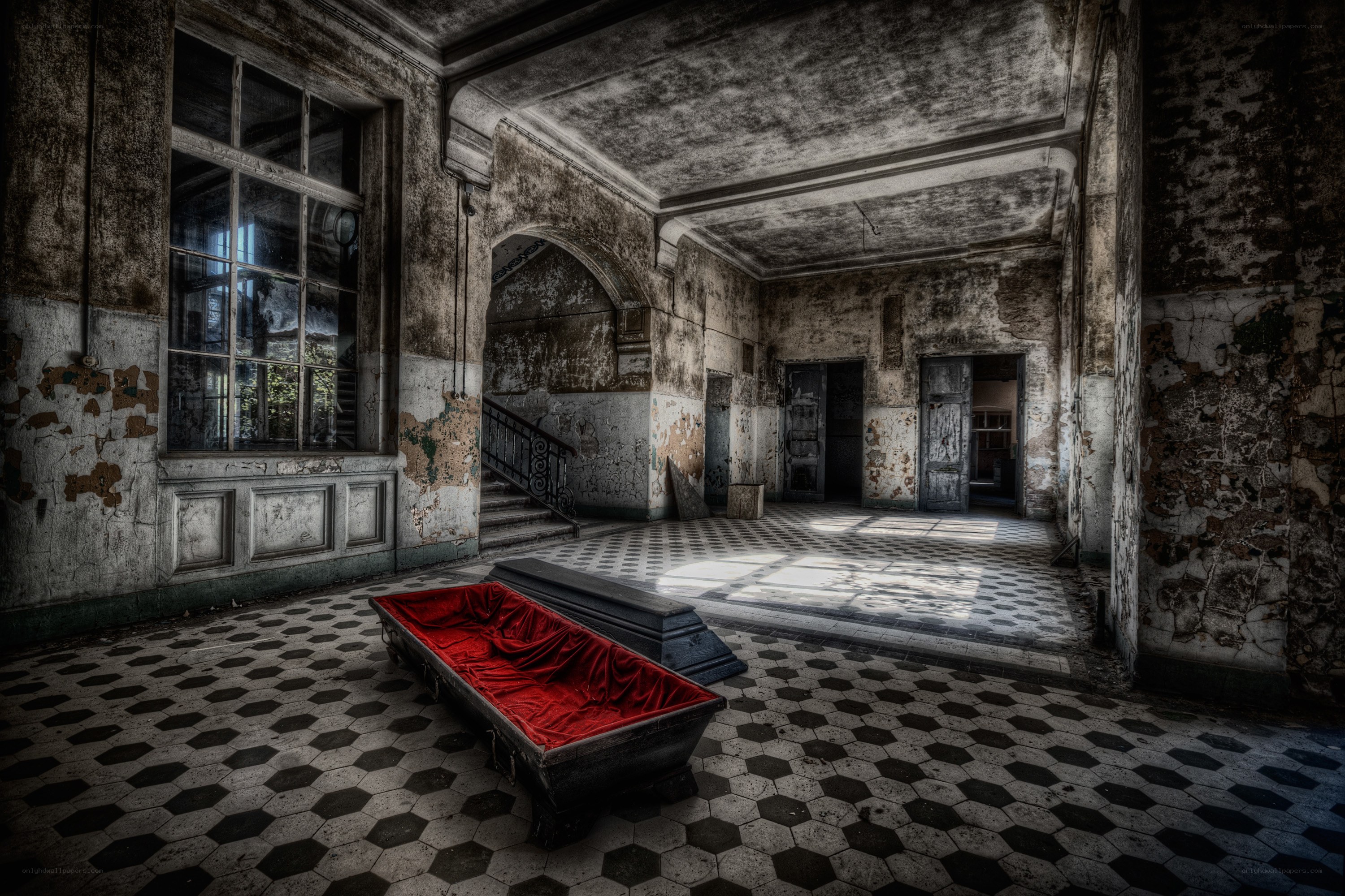 Abandoned hall with red coffin