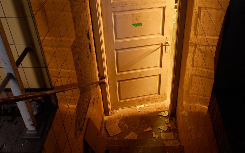 abandoned hallway with broken door