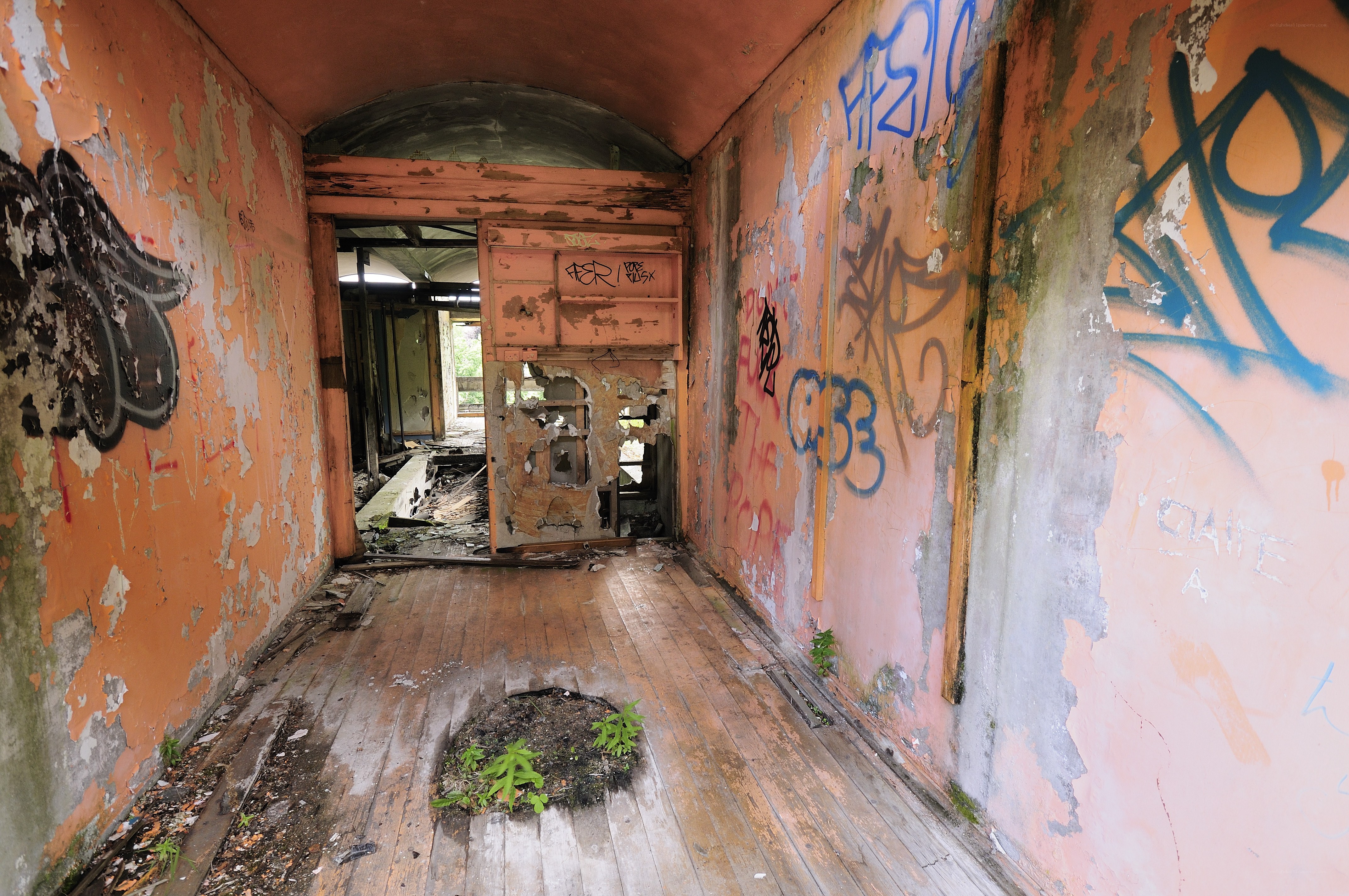 abandoned hallway with graffiti