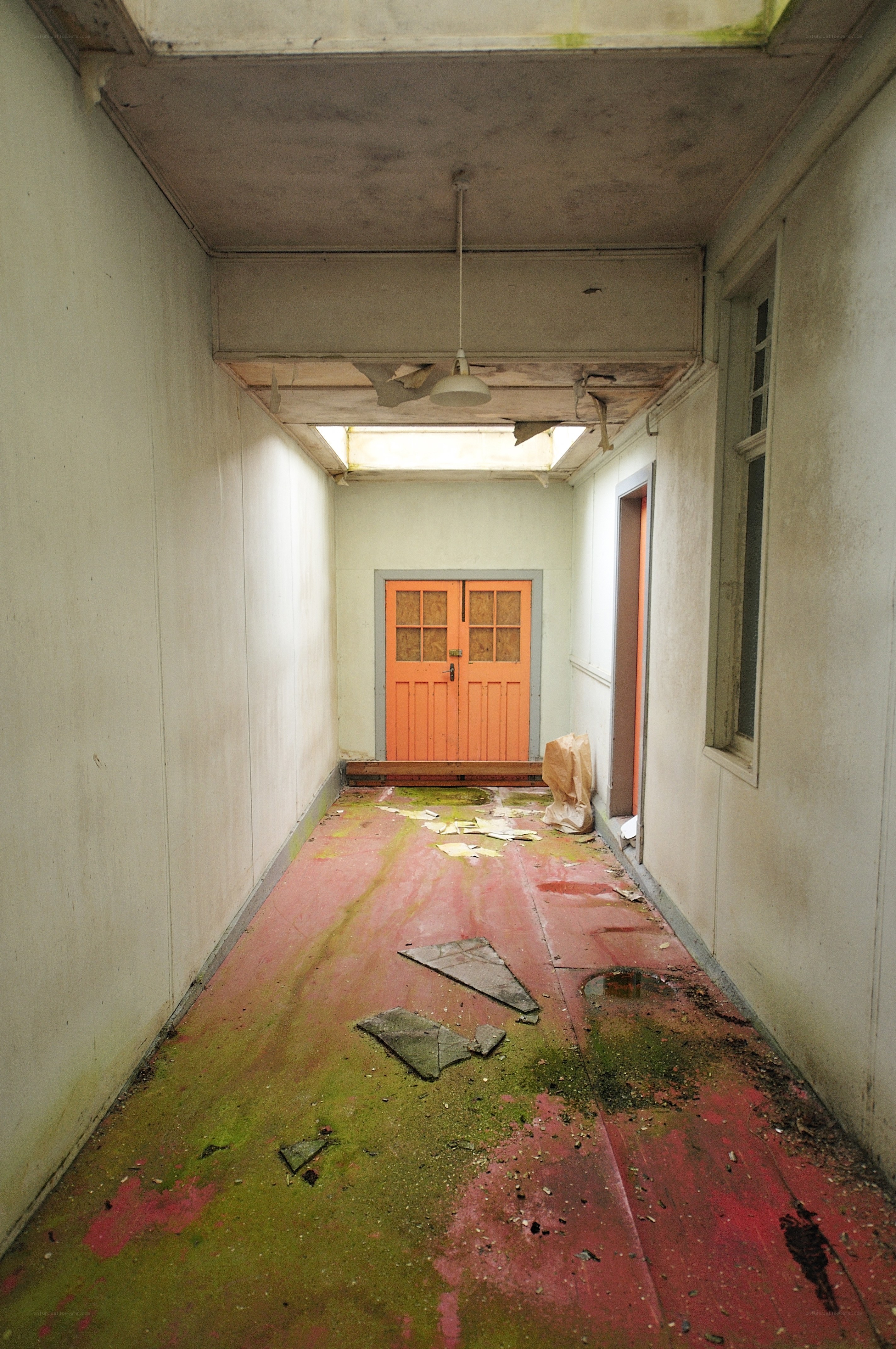 abandoned hallway with orange door