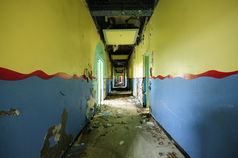 abandoned hallway with peeling paint