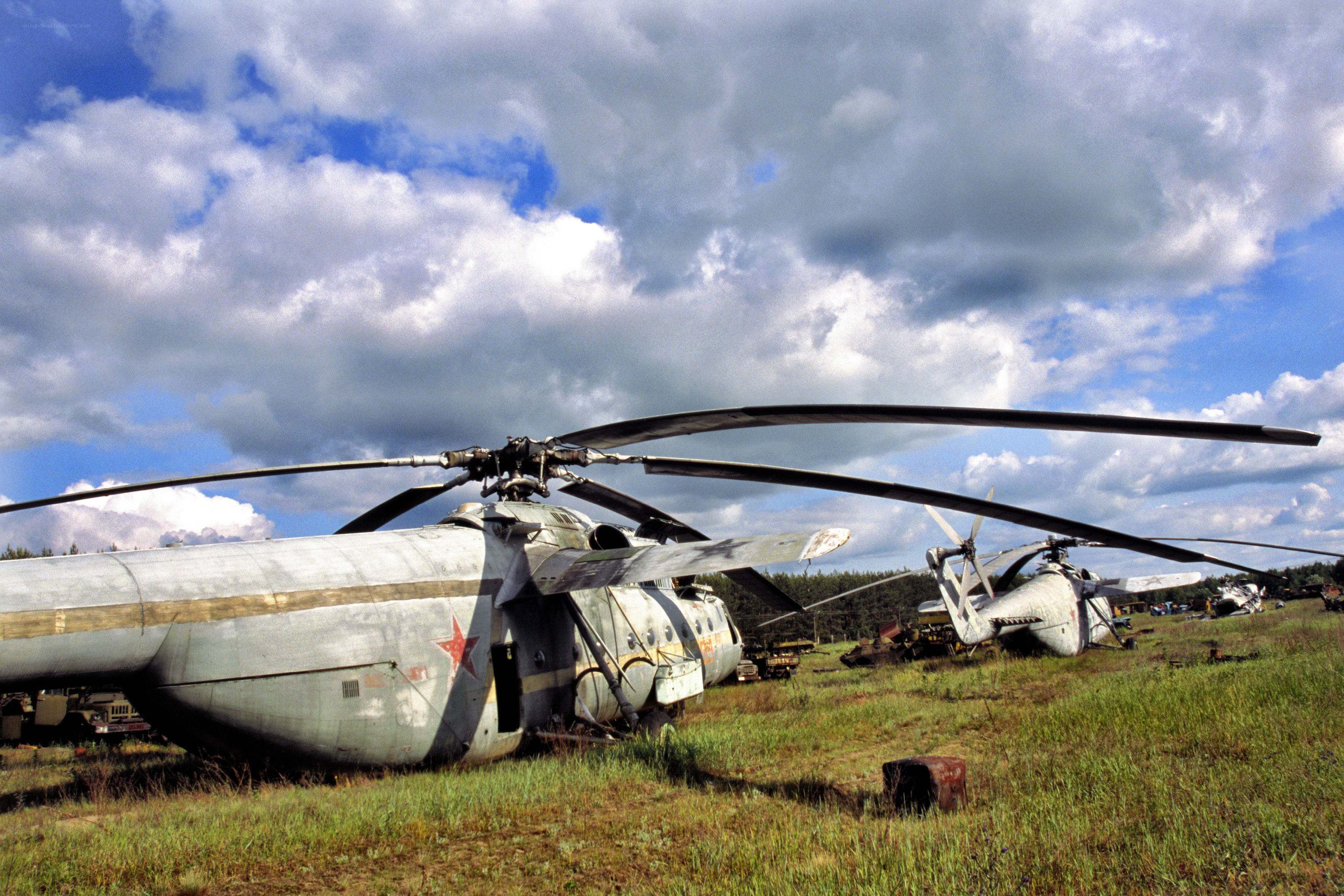 Abandoned helicopters in a field