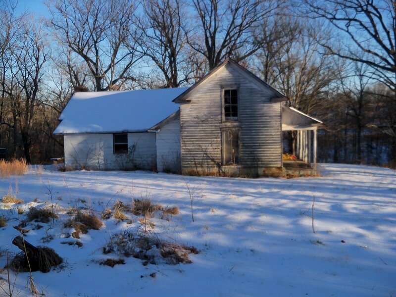 Abandoned house in snowy landscape