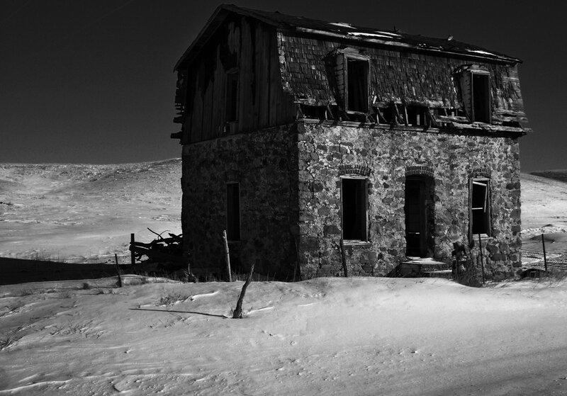 Abandoned house in snowy landscape