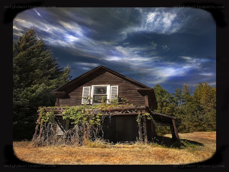 abandoned house under stormy sky