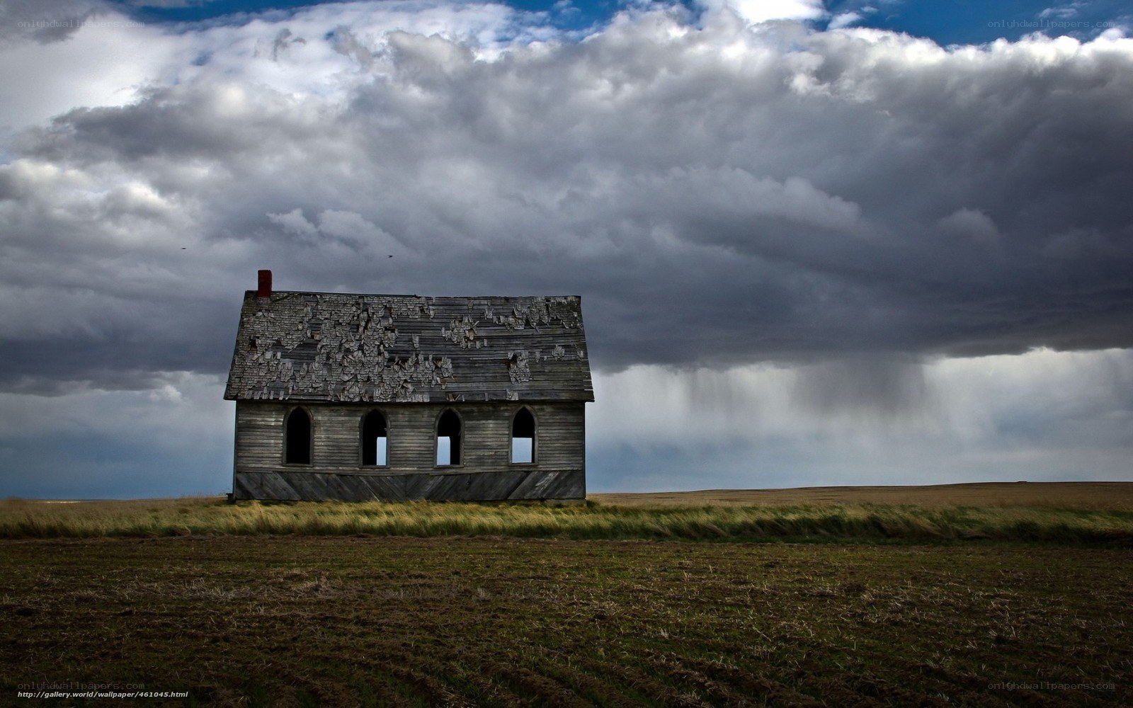 Abandoned house under stormy sky