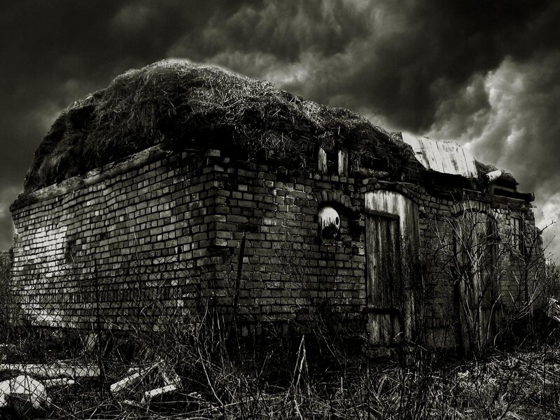 Abandoned hut under stormy sky
