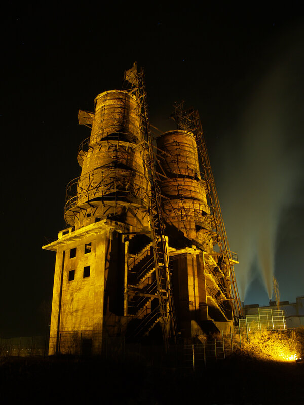 Abandoned industrial towers at night