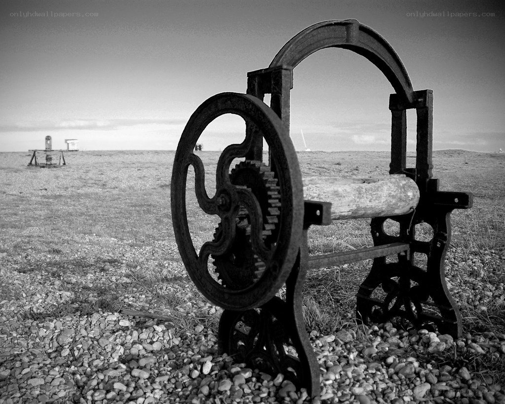 Abandoned machinery on a pebble beach