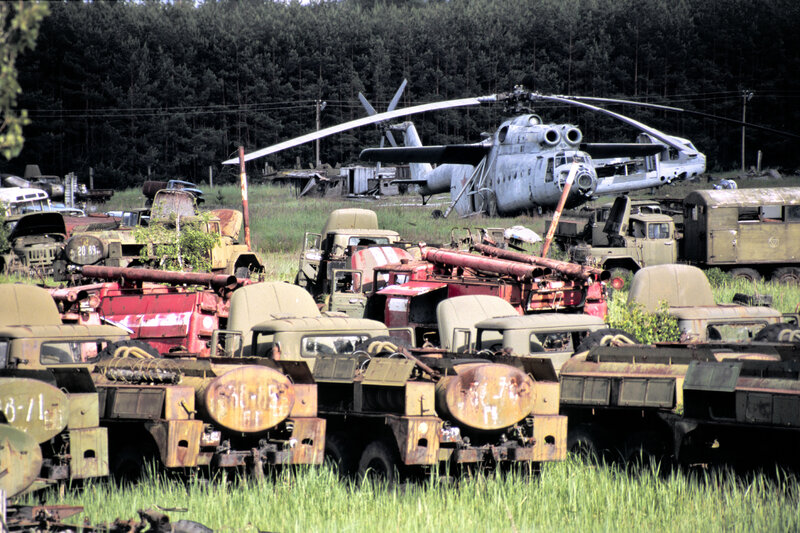 Abandoned military vehicles and helicopter