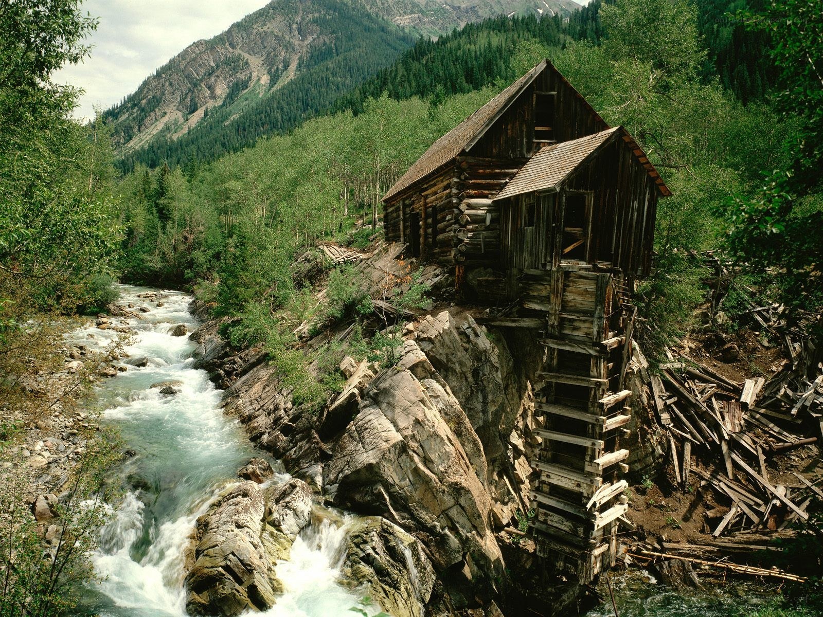 Abandoned mill by a mountain river