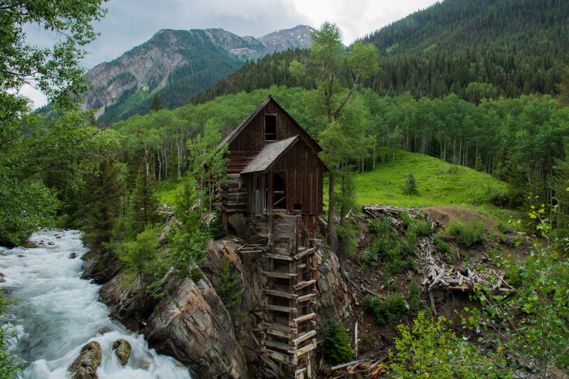 Abandoned mill by a mountain river