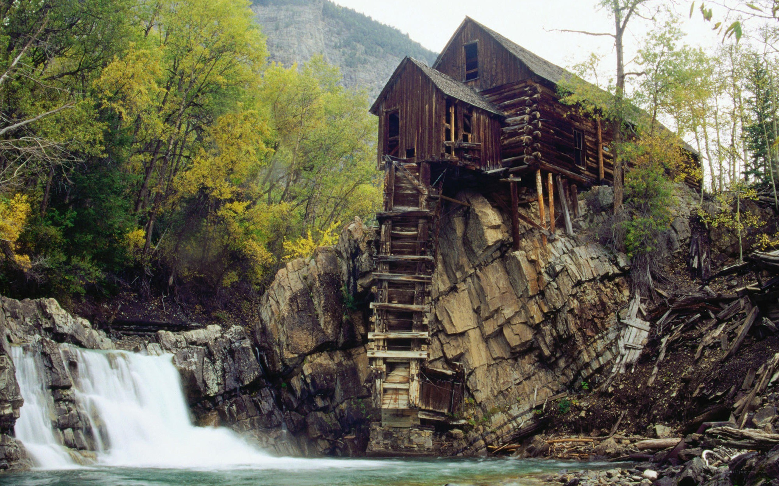 Abandoned mill by a waterfall