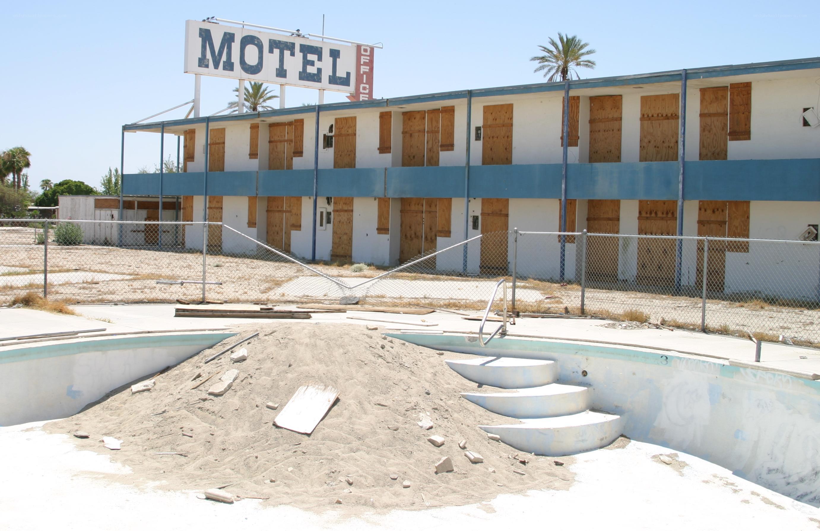 abandoned motel with boarded windows