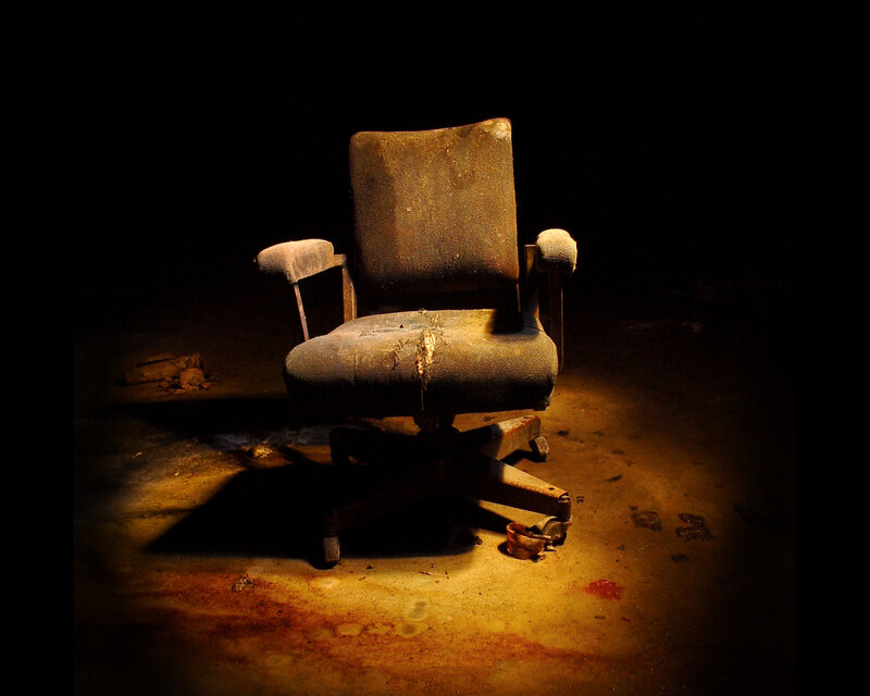 abandoned office chair in darkness